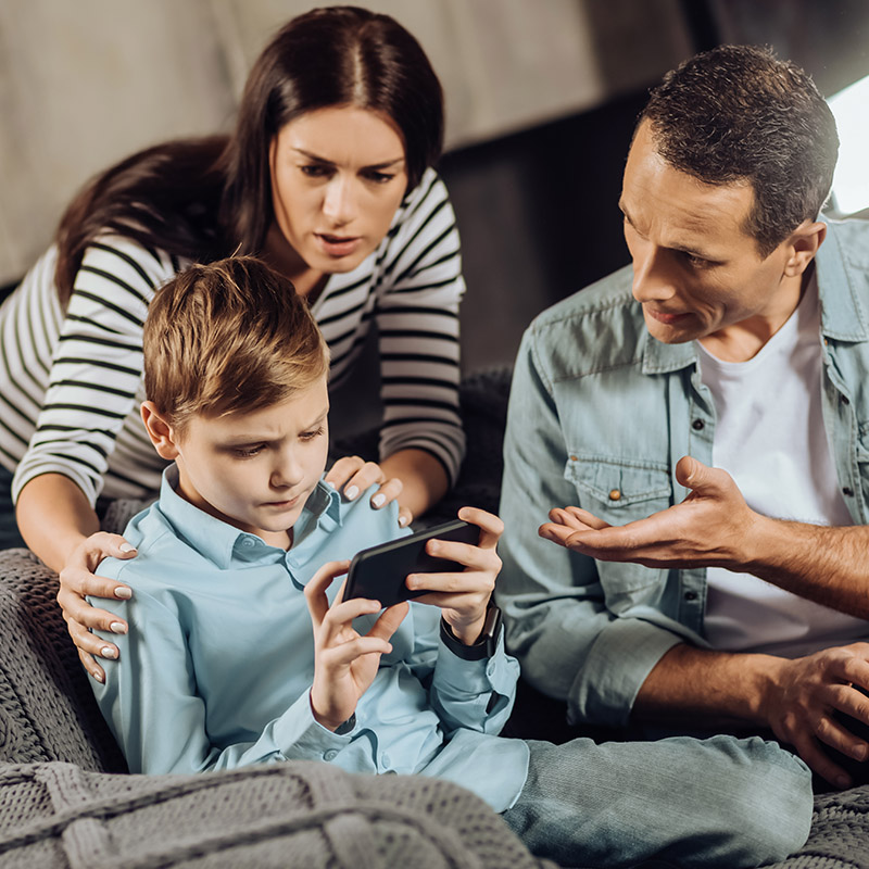 Loving parents convincing son to put down the phone